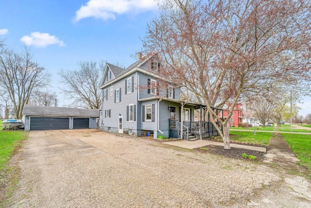 2523 Woods St, West Brooklyn, IL 61378 - view of home's exterior featuring a garage, a chimney, covered porch, and an outdoor structure