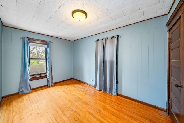 2523 Woods St, West Brooklyn, IL 61378 - spare room with baseboards, light wood-style floors, and wooden walls