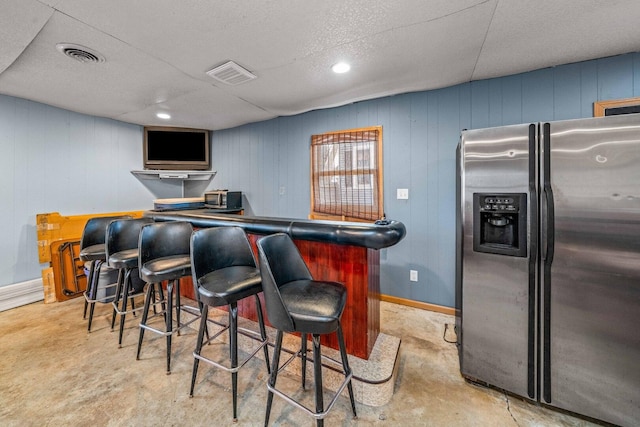 2523 Woods St, West Brooklyn, IL 61378 - bar featuring stainless steel refrigerator with ice dispenser, a dry bar, a textured ceiling, and visible vents