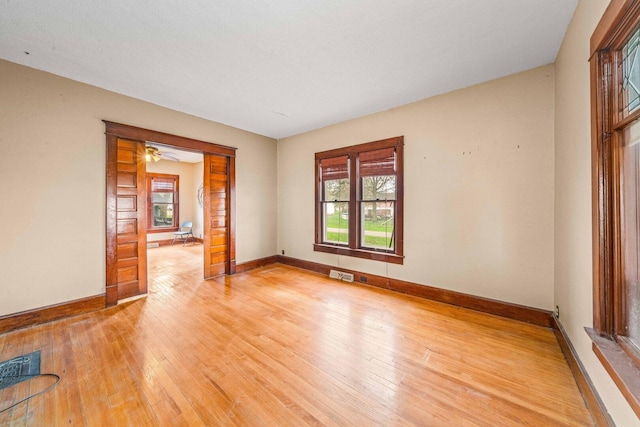 2523 Woods St, West Brooklyn, IL 61378 - spare room with baseboards, visible vents, and light wood finished floors