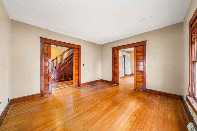 2523 Woods St, West Brooklyn, IL 61378 - unfurnished living room with light wood-type flooring, baseboards, and stairway