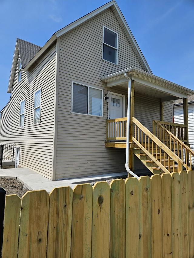 back of house with fence and stairs
