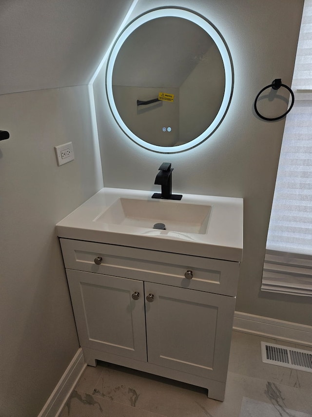bathroom featuring marble finish floor, vanity, baseboards, and visible vents
