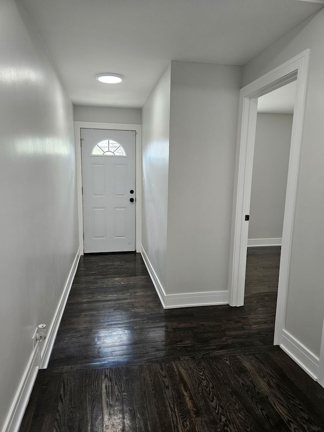 entryway with baseboards and dark wood-style floors