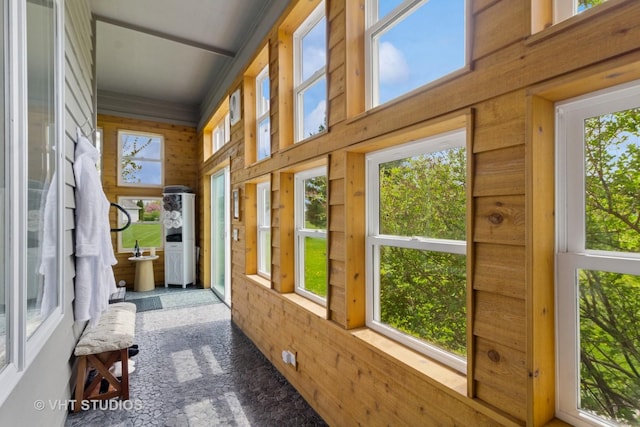 sunroom / solarium with wooden walls and a healthy amount of sunlight