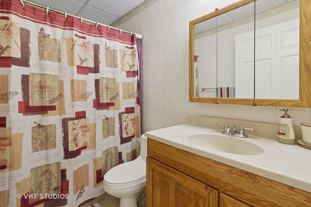 full bath featuring a shower with curtain, backsplash, tile walls, vanity, and toilet