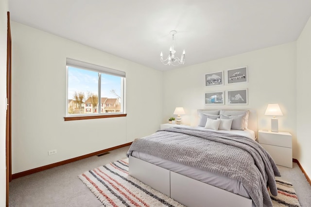 bedroom with visible vents, carpet flooring, baseboards, and an inviting chandelier