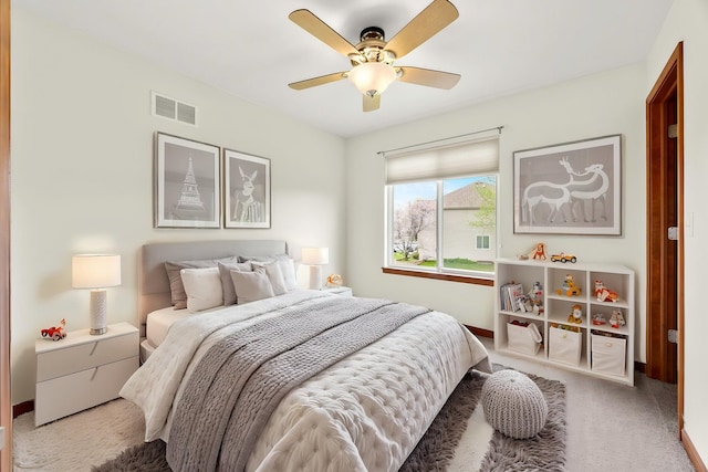 bedroom with carpet floors, visible vents, a ceiling fan, and baseboards
