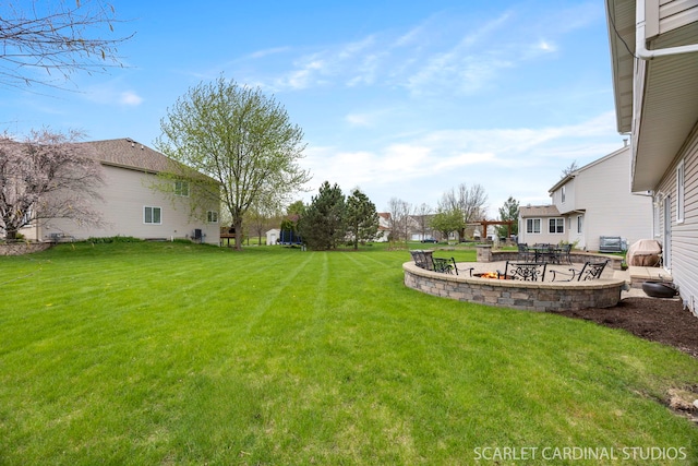view of yard with a patio and an outdoor fire pit