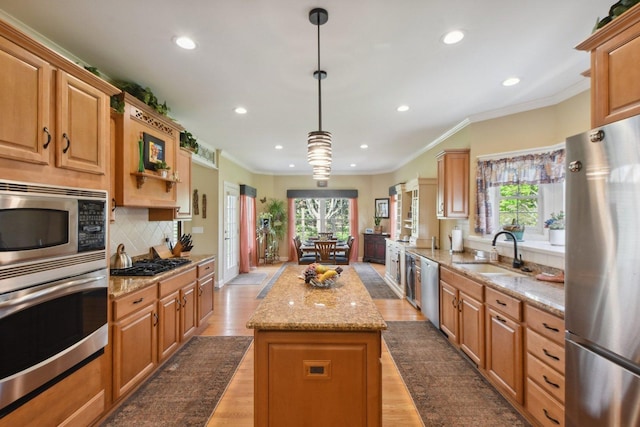 7160 Bannockburn Cir, Lakewood, IL 60014 - kitchen featuring appliances with stainless steel finishes, a center island, a healthy amount of sunlight, and a sink