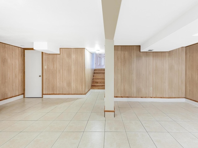 bonus room with wooden walls and stairway