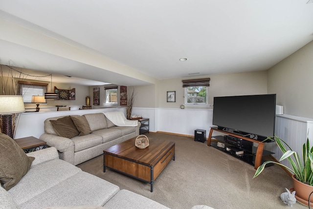 living area featuring carpet and a wainscoted wall