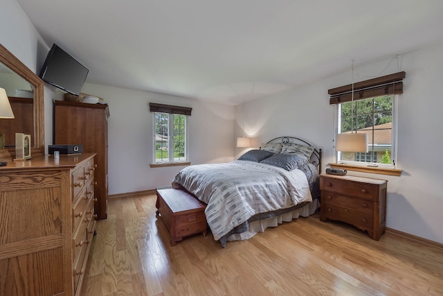bedroom with light wood-style floors and baseboards
