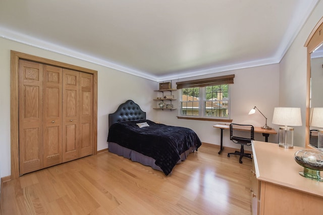 bedroom featuring light wood-style floors and baseboards