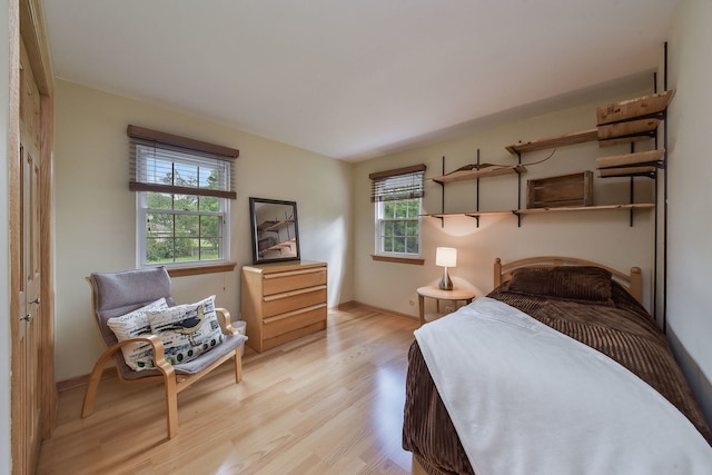 bedroom with baseboards and light wood-type flooring