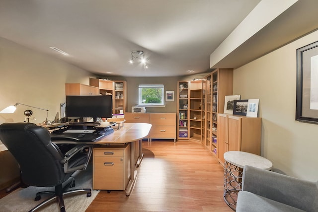 home office with light wood-style floors