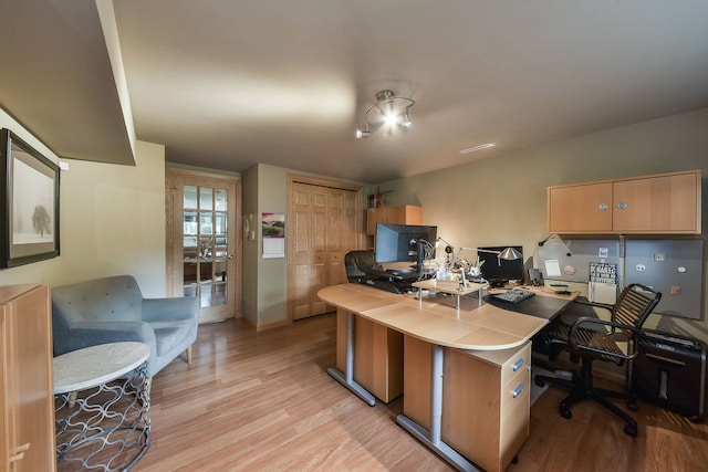 office featuring baseboards and light wood-type flooring