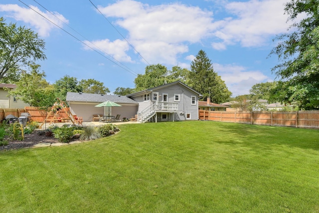 view of yard with a fenced backyard, a patio area, and stairway