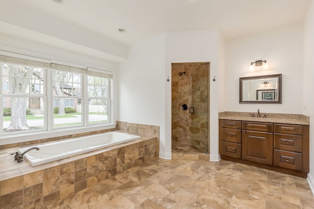 bathroom with a shower stall, a garden tub, and vanity