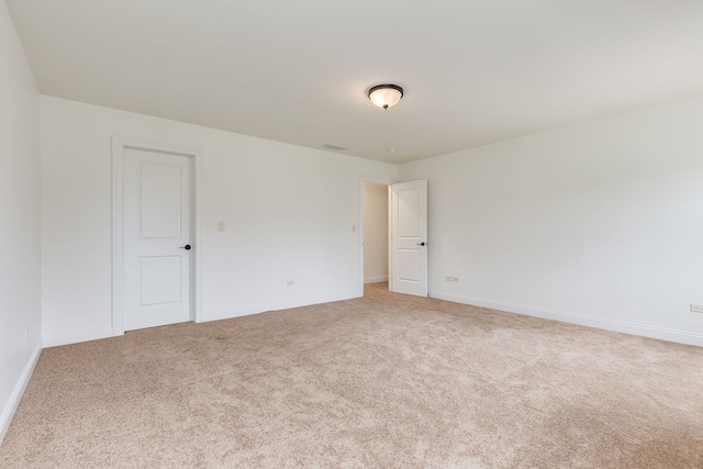 carpeted empty room with baseboards