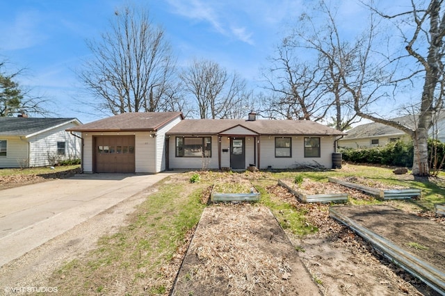 127 Tilton Park Dr, Dekalb, IL 60115 - ranch-style house featuring an attached garage, driveway, a garden, and a chimney