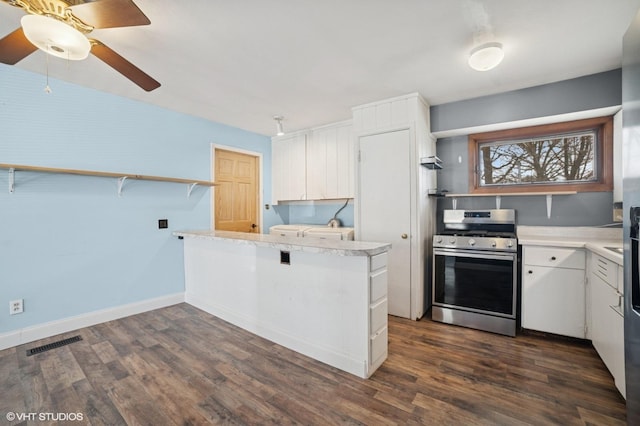 127 Tilton Park Dr, Dekalb, IL 60115 - kitchen with white cabinets, light countertops, visible vents, stainless steel gas range, and a peninsula