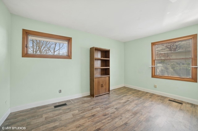 127 Tilton Park Dr, Dekalb, IL 60115 - unfurnished room with wood finished floors, visible vents, and baseboards