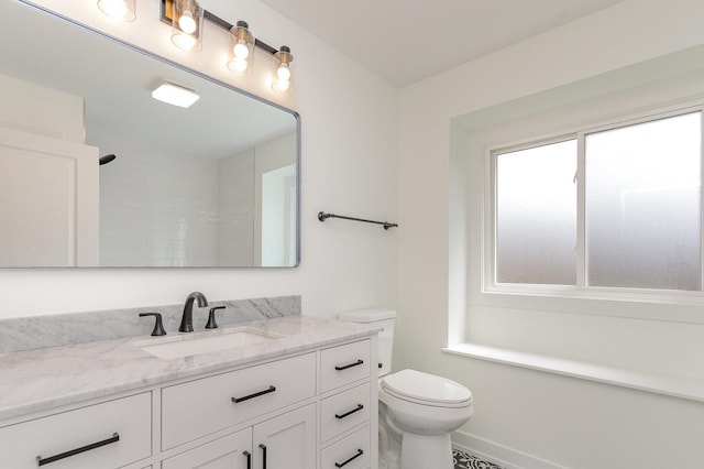 bathroom with walk in shower, baseboards, toilet, and vanity