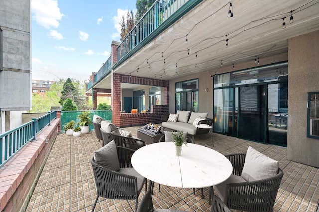 view of patio / terrace with an outdoor living space and a balcony