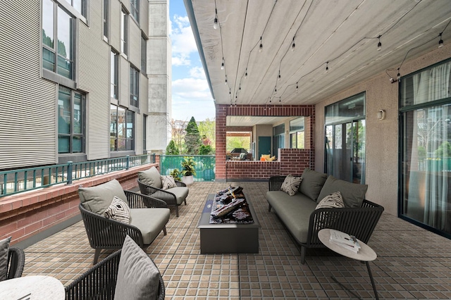 view of patio / terrace with an outdoor living space with a fire pit