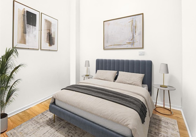 bedroom with wood finished floors and baseboards