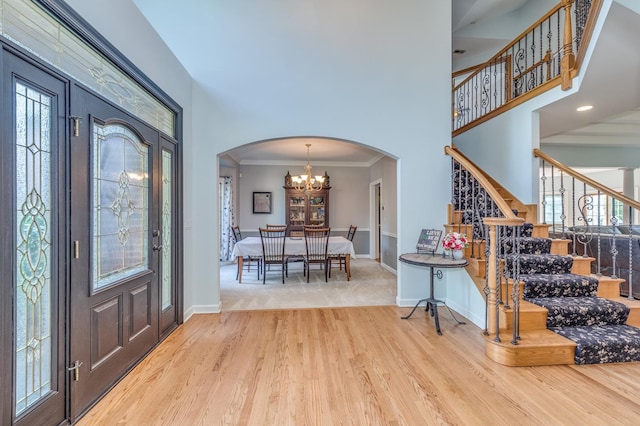 3908 Royal Portrush Dr, Naperville, IL 60564 - entryway featuring wood finished floors, stairway, arched walkways, a high ceiling, and baseboards