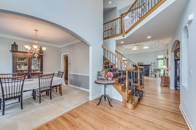 3908 Royal Portrush Dr, Naperville, IL 60564 - dining room featuring wood finished floors, a chandelier, ornamental molding, stairway, and baseboards