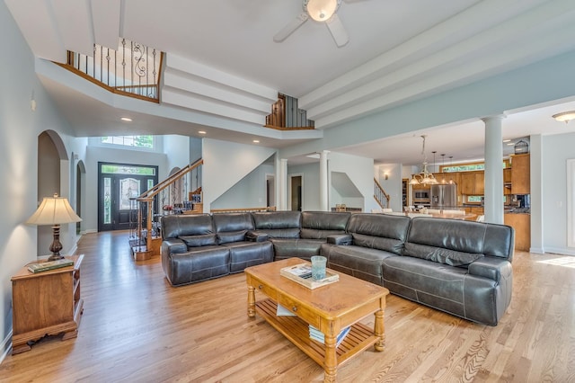 3908 Royal Portrush Dr, Naperville, IL 60564 - living area with stairs, light wood finished floors, baseboards, a ceiling fan, and decorative columns