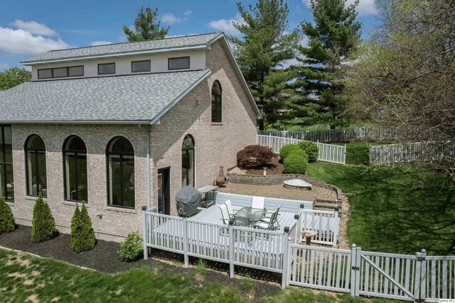 5620 Ridgeline Dr, Quincy, IL 62305 - back of house featuring a shingled roof, a deck, a fenced backyard, and brick siding
