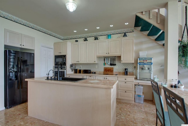 5620 Ridgeline Dr, Quincy, IL 62305 - kitchen featuring black appliances, backsplash, light countertops, a kitchen island with sink, and recessed lighting