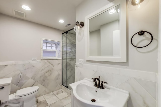 2642 N Drake Ave, Chicago, IL 60647 - bathroom featuring a sink, toilet, tile walls, a stall shower, and visible vents