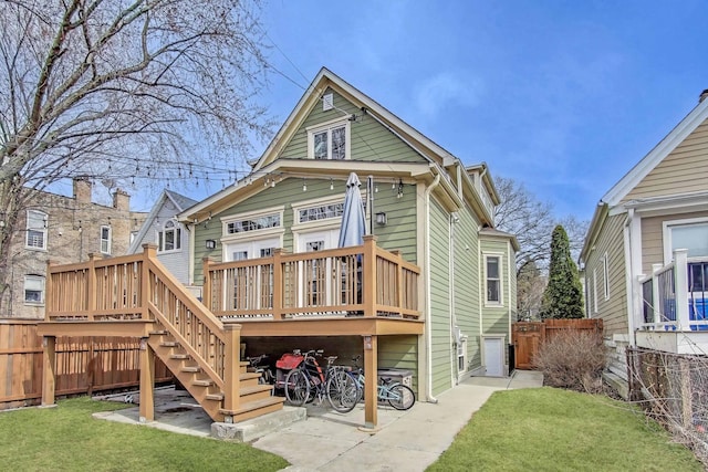 2642 N Drake Ave, Chicago, IL 60647 - back of house with fence, a wooden deck, stairs, and a yard