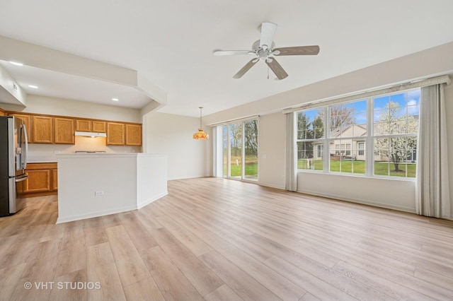 unfurnished living room with baseboards, a ceiling fan, light wood-style flooring, and recessed lighting