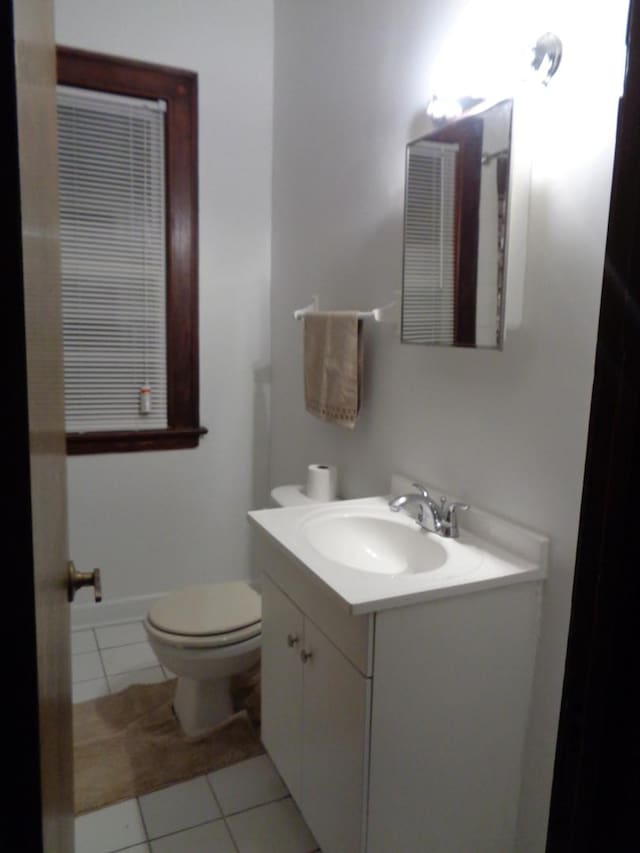 bathroom featuring vanity, toilet, and tile patterned flooring