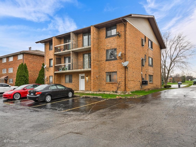 view of property featuring uncovered parking