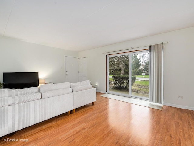 living room featuring light wood-style flooring and baseboards