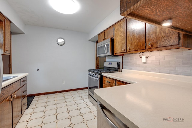 33170 N Battershall Rd, Grayslake, IL 60030 - kitchen with stainless steel appliances, light flooring, backsplash, and light countertops
