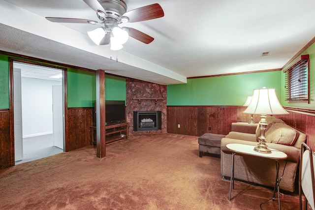 33170 N Battershall Rd, Grayslake, IL 60030 - living area with a wainscoted wall, wood walls, carpet flooring, a large fireplace, and a ceiling fan