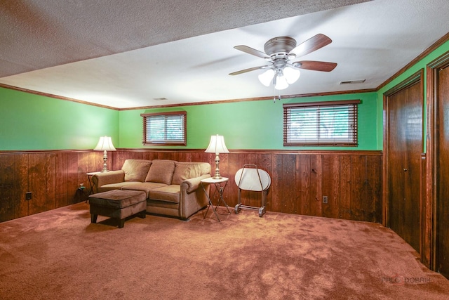 33170 N Battershall Rd, Grayslake, IL 60030 - living area with wainscoting, carpet floors, crown molding, wooden walls, and ceiling fan