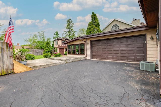 33170 N Battershall Rd, Grayslake, IL 60030 - view of front of property featuring cooling unit, asphalt driveway, a garage, and a chimney