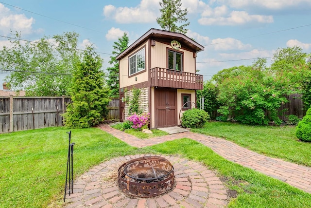 33170 N Battershall Rd, Grayslake, IL 60030 - back of property featuring an outdoor fire pit and a balcony