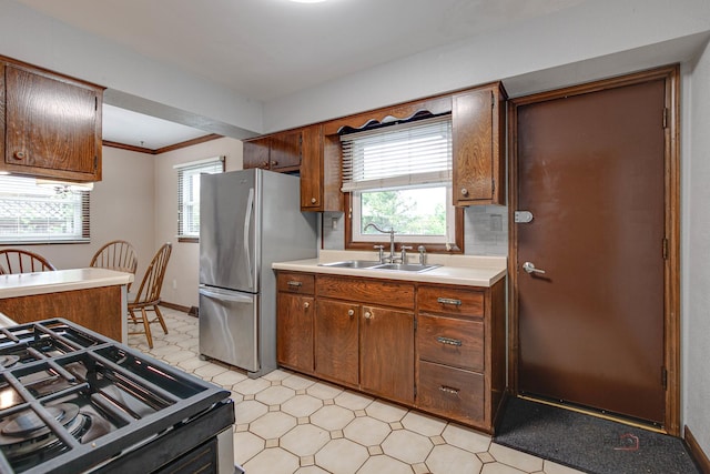 33170 N Battershall Rd, Grayslake, IL 60030 - kitchen featuring freestanding refrigerator, black range with gas stovetop, light flooring, a sink, and light countertops