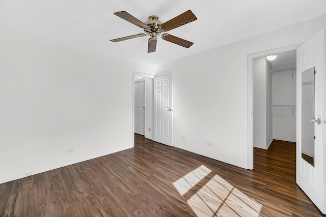 unfurnished bedroom featuring wood finished floors, a ceiling fan, and baseboards