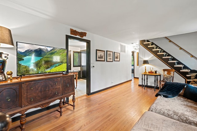 5802 Tennessee Ave, Clarendon Hills, IL 60514 - living room with visible vents, stairway, light wood finished floors, and baseboards